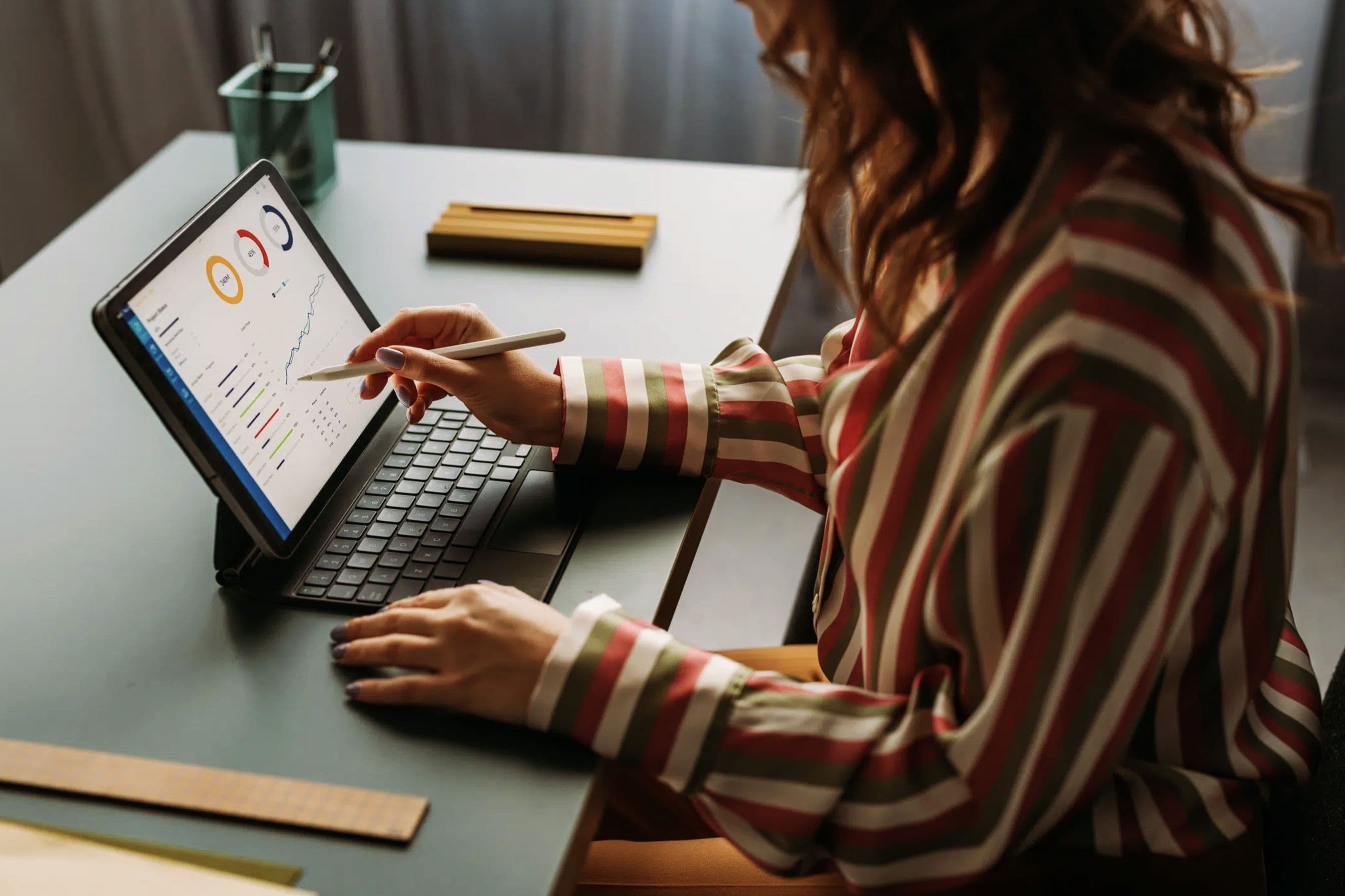 A woman reviewing data on her laptop.